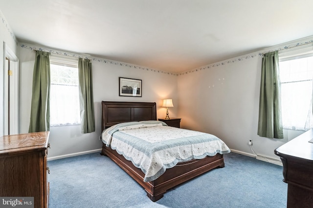 carpeted bedroom with baseboards and a baseboard heating unit