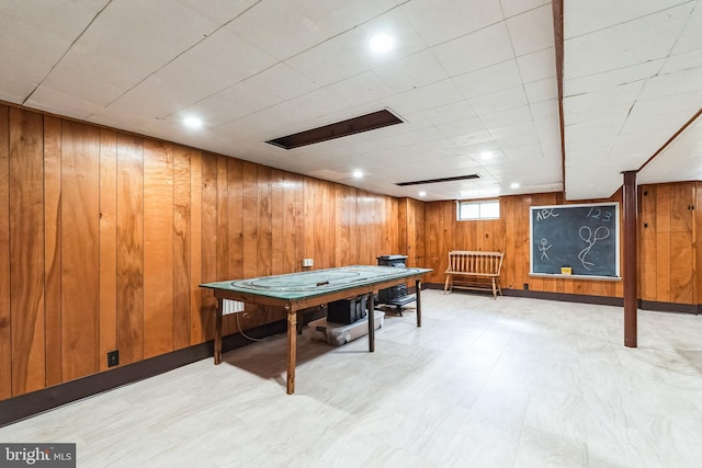 playroom with wooden walls and light floors