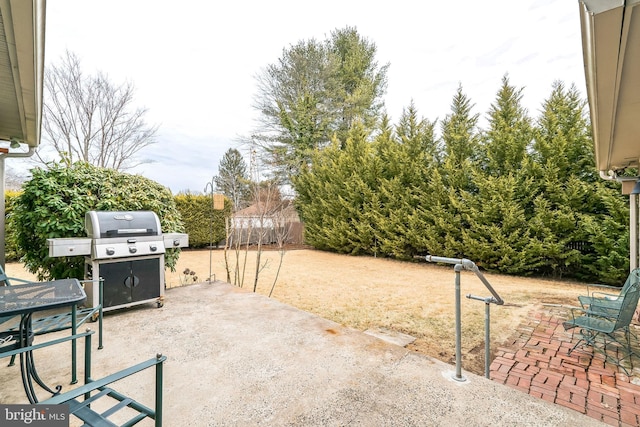 view of patio / terrace featuring a grill and fence