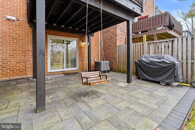 view of patio / terrace featuring central AC unit, fence, and area for grilling