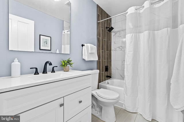 bathroom with toilet, shower / tub combo, and vanity