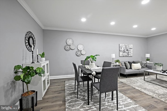 dining space featuring baseboards, ornamental molding, dark wood finished floors, and recessed lighting