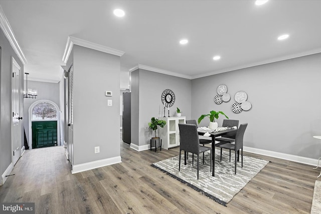 dining room featuring baseboards, wood finished floors, and recessed lighting