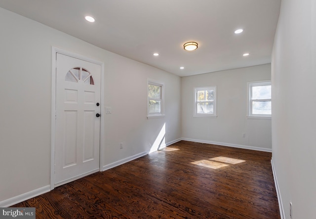 entrance foyer featuring dark wood-type flooring, recessed lighting, and baseboards