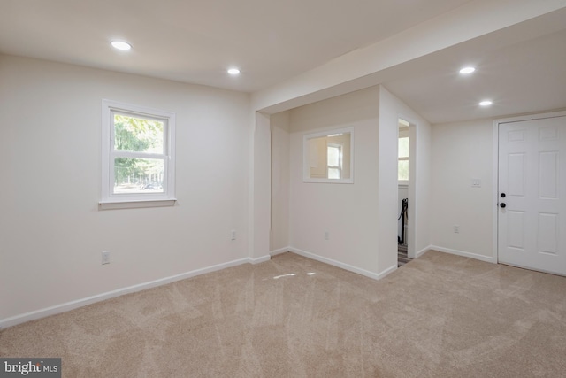 interior space featuring recessed lighting, light colored carpet, and baseboards