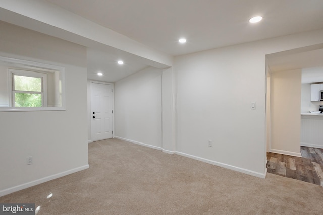 basement with light carpet, baseboards, and recessed lighting