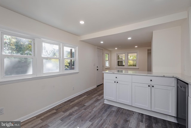 kitchen featuring baseboards, dark wood-type flooring, a peninsula, light countertops, and white cabinetry