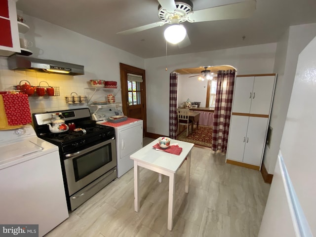 kitchen with washer / dryer, under cabinet range hood, decorative backsplash, and gas range