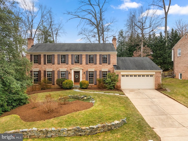 view of front of house with a garage, brick siding, concrete driveway, a chimney, and a front yard