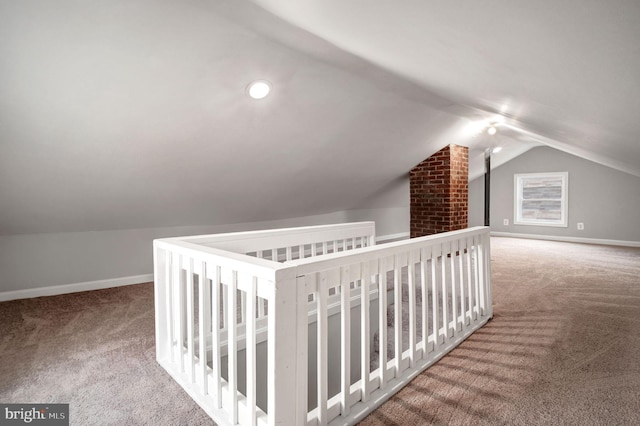 bonus room featuring lofted ceiling, carpet floors, and baseboards