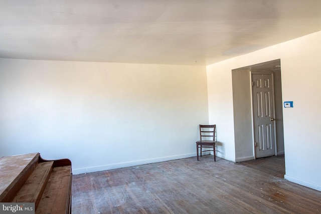 spare room with wood finished floors and baseboards