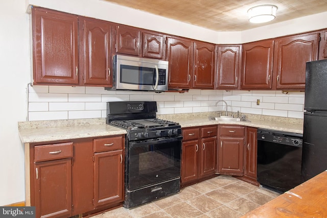 kitchen with black appliances, decorative backsplash, a sink, and light countertops