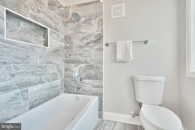 full bath featuring visible vents, bathing tub / shower combination, toilet, and baseboards