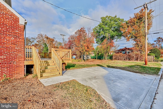 view of yard with a patio, stairway, and a wooden deck