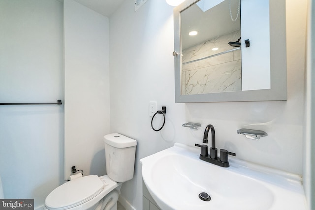 full bathroom with toilet and a sink