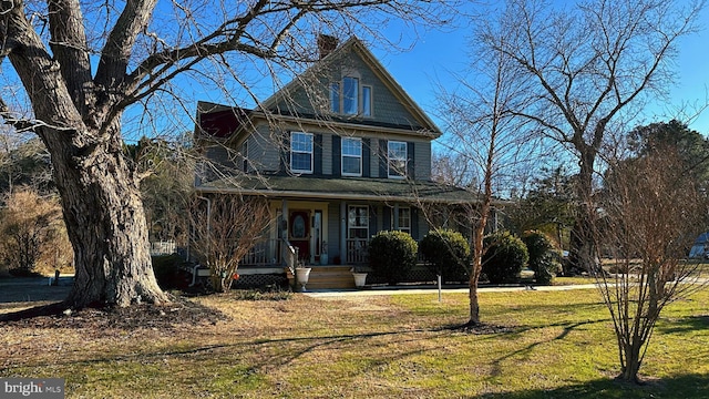 view of front facade featuring a front yard and a chimney