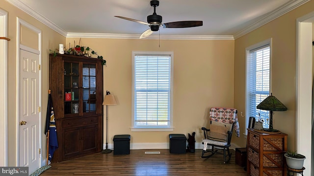 sitting room with a healthy amount of sunlight, baseboards, ornamental molding, and dark wood-style flooring