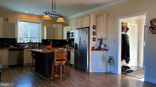 kitchen with stainless steel appliances, a breakfast bar, a kitchen island, dark countertops, and decorative light fixtures