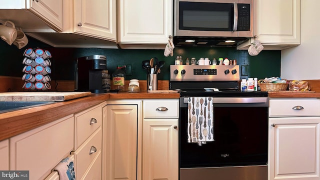 kitchen featuring appliances with stainless steel finishes and white cabinetry