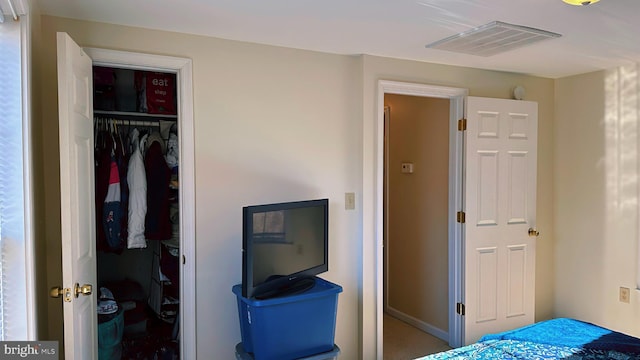 bedroom with visible vents and a closet