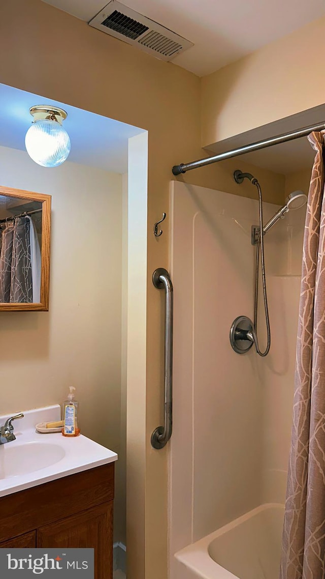 full bathroom featuring visible vents, shower / bathtub combination with curtain, and vanity