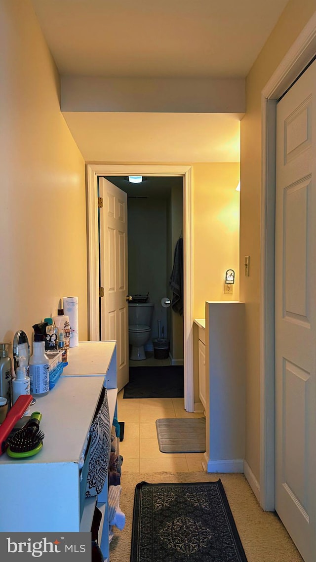 bathroom featuring baseboards and toilet