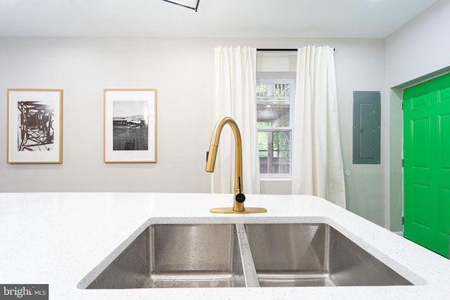 room details with light countertops, a sink, and electric panel