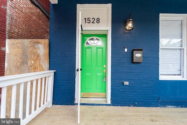 property entrance with brick siding