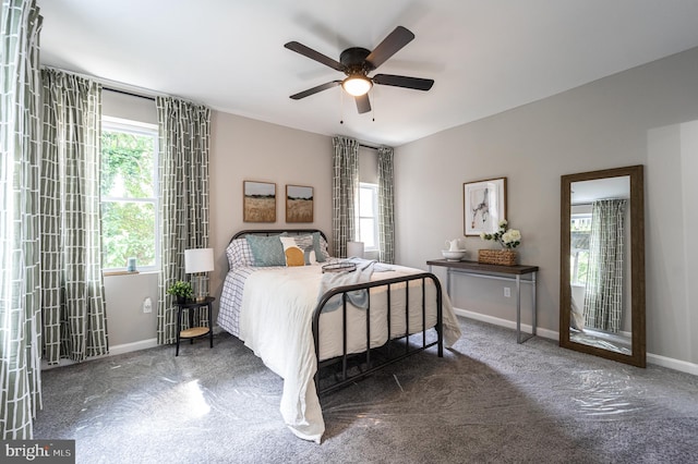 bedroom with ceiling fan and baseboards