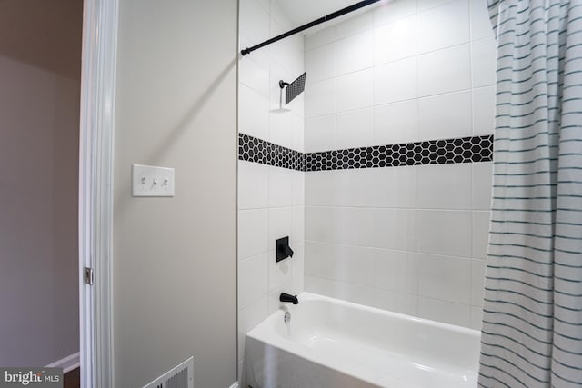 full bathroom with shower / bathtub combination with curtain and baseboards