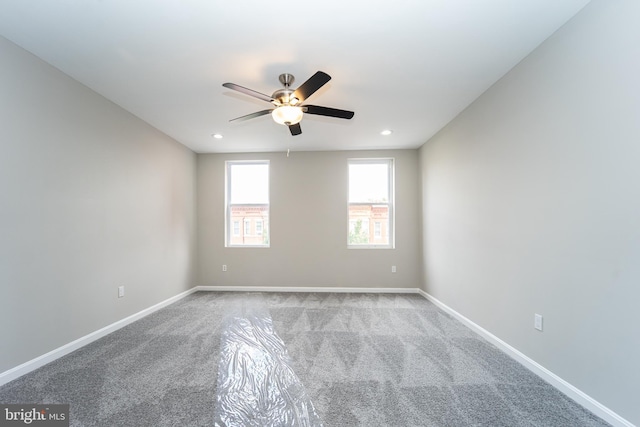 carpeted spare room featuring baseboards, a ceiling fan, and recessed lighting