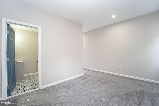 empty room with carpet floors, recessed lighting, and baseboards