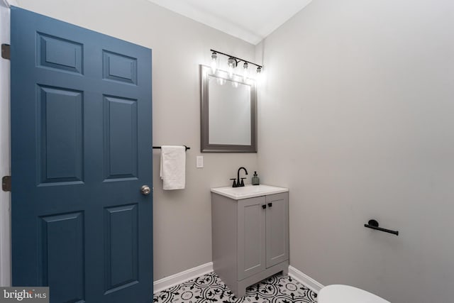 bathroom featuring tile patterned flooring, vanity, and baseboards