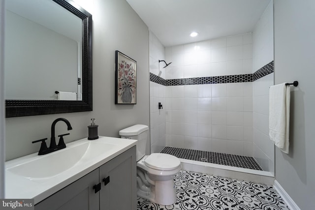 full bathroom featuring toilet, tile patterned flooring, a tile shower, vanity, and recessed lighting