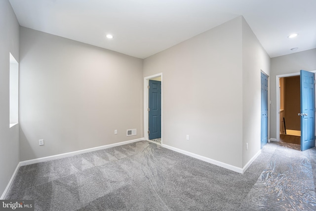 unfurnished room with recessed lighting, visible vents, and baseboards