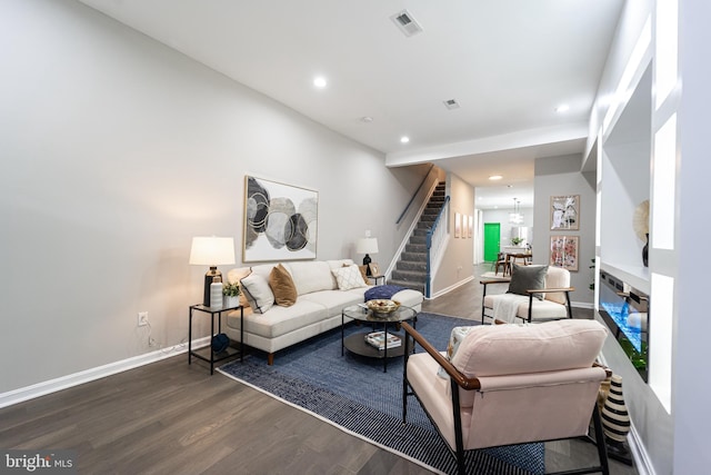 living area with stairs, dark wood-type flooring, recessed lighting, and baseboards