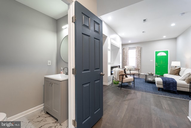 interior space with recessed lighting, a fireplace, and baseboards