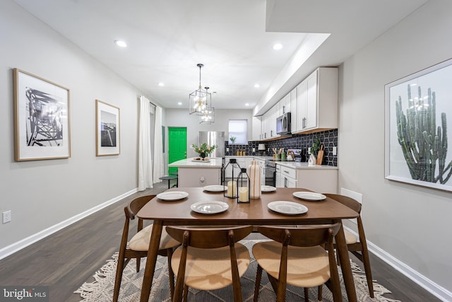 dining room featuring baseboards, dark wood finished floors, and recessed lighting