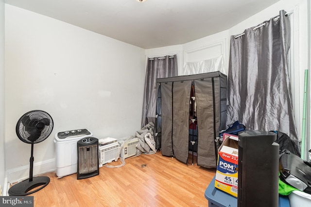 misc room featuring wood finished floors and baseboards