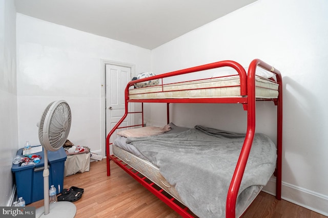 bedroom featuring baseboards and wood finished floors