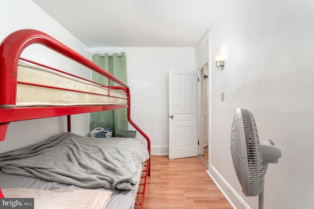 bedroom featuring light wood-type flooring and baseboards