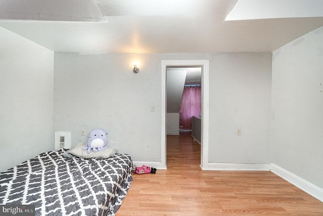 bedroom with baseboards and light wood finished floors