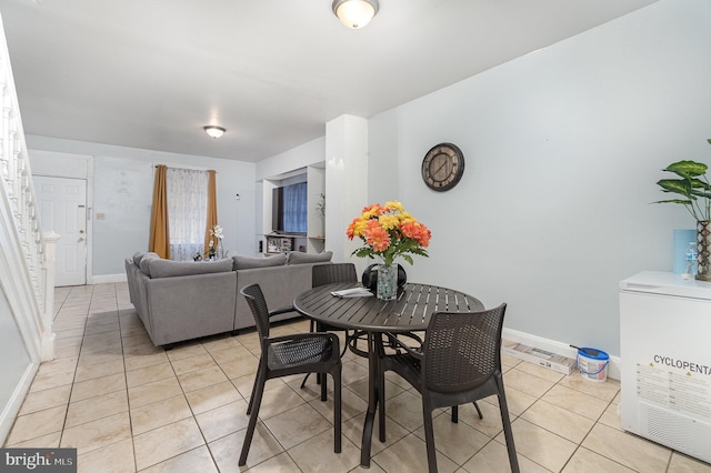 dining area with baseboards and light tile patterned flooring