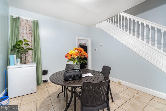 dining area featuring baseboards and light tile patterned floors