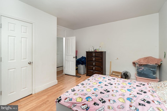 bedroom featuring light wood-style flooring and baseboards