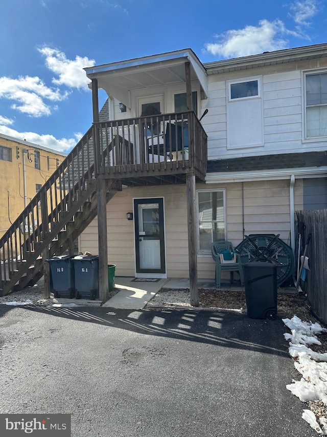 back of house with stairs and fence