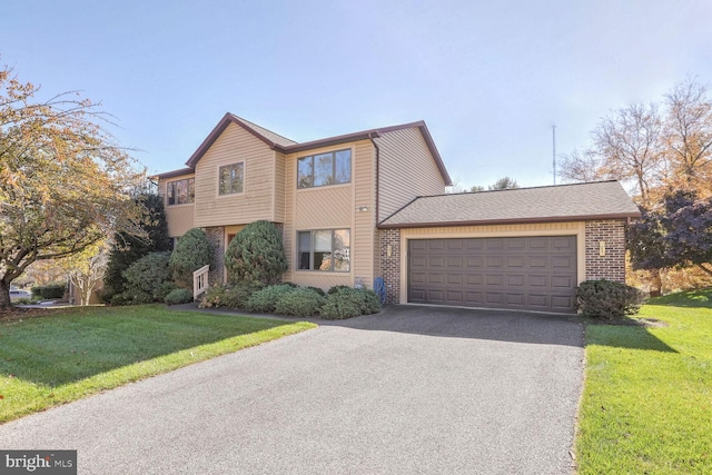 view of front of property with a garage, a front yard, brick siding, and driveway