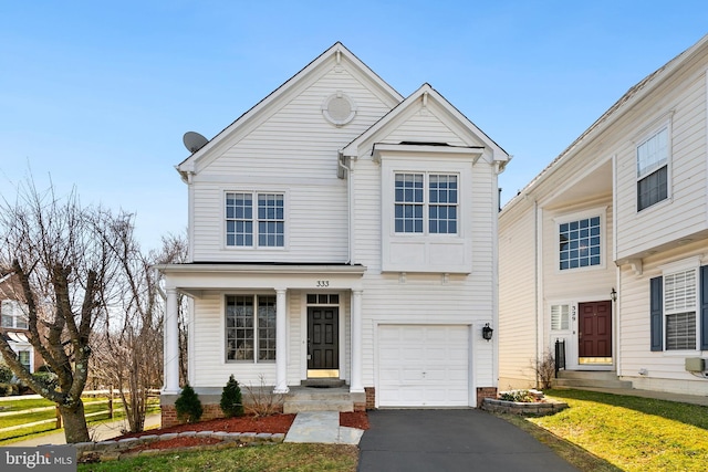 traditional home with aphalt driveway and an attached garage