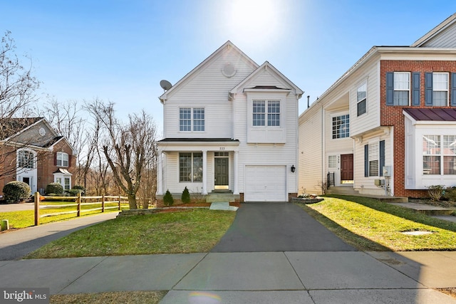 view of front of property with driveway, a garage, fence, and a front yard