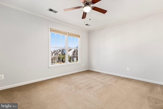 unfurnished room with baseboards, visible vents, crown molding, and carpet flooring